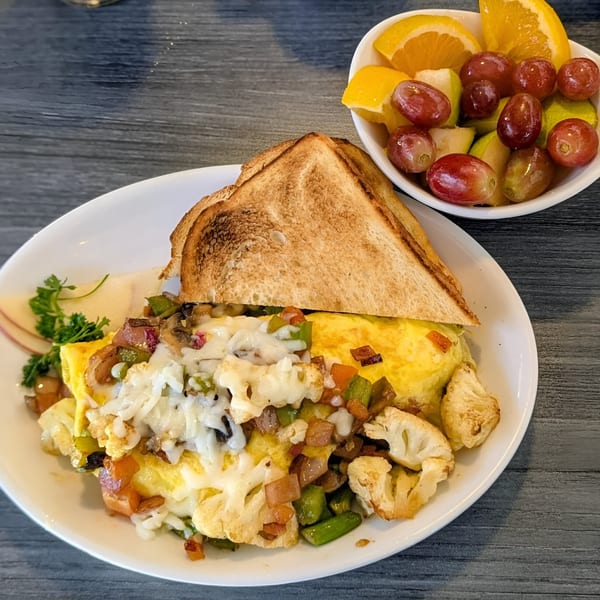 Hot Off the Griddle's breakfast omelet with toast and a side of fresh fruit.